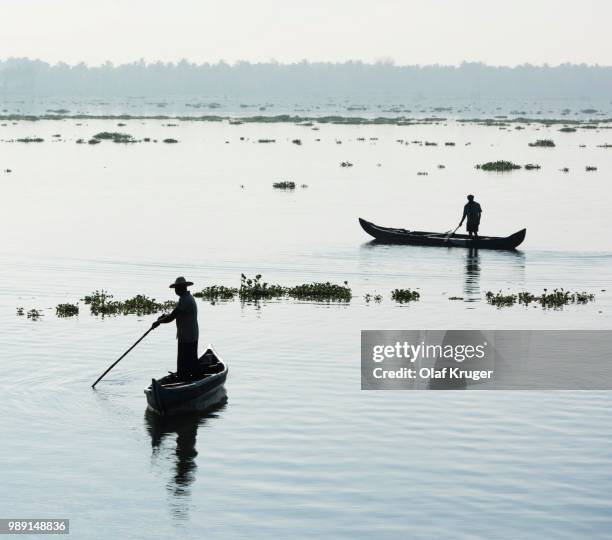 men in small boats, vembanad lake, kerala, south india, india - malabar_coast stock pictures, royalty-free photos & images