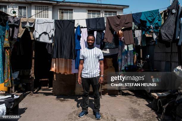 Nigerian actor Abiodun Kassim, poses in the Oju Elegba neighbourhood where the film was shot on June 11 in Lagos. - Nigerian film director Ema Edosio...