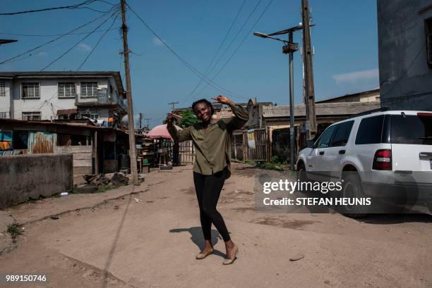 Nigerian film director of the Nollywood film "Kasala" Ema Edosio poses in a street of Lagos on June 11, 2018. - Nigerian film director Ema Edosio...