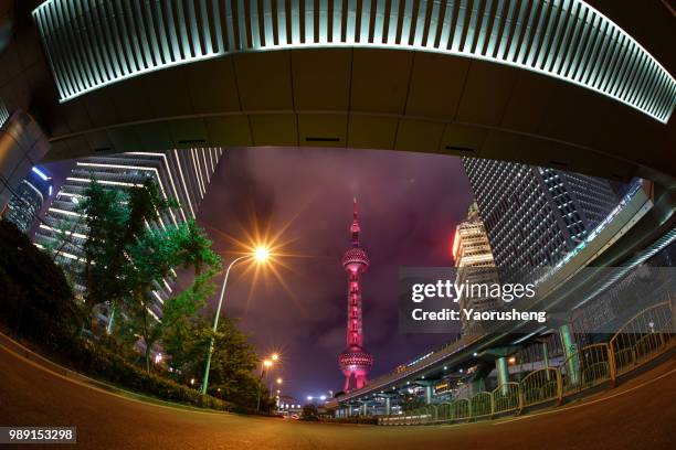 shanghai orient pearl tower illuminated in red in the night,celebrating a chinese traditional holiday,china - pearl district stock pictures, royalty-free photos & images