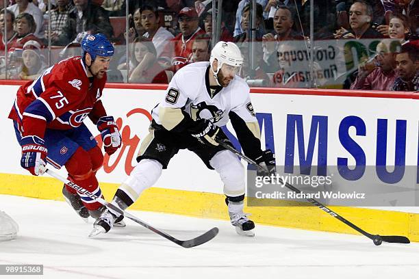 Pascal Dupuis of the Pittsburgh Penguins skates with the puck while being defended by Hal Gill of the Montreal Canadiens in Game Four of the Eastern...