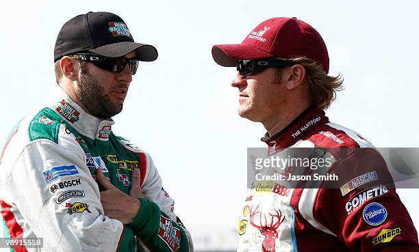 Elliott Sadler, driver of the Hunt Brothers Pizza Ford, talks with Clint Bowyer, driver of the The Hartford Chevrolet, during qualifying for the...