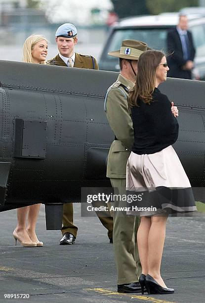 Prince Harry and girlfriend Chelsy Davy chat together following his pilot course graduation at the Army Aviation Centre on May 7, 2010 in Andover,...