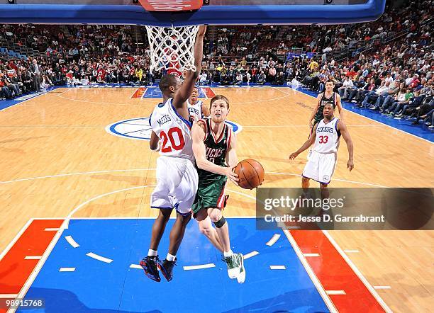 Luke Ridnour of the Milwaukee Bucks makes a layup against Jodie Meeks of the Philadelphia 76ers during the game at Wachovia Center on April 9, 2010...