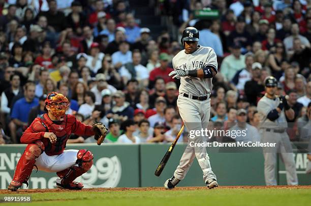 Robinson Cano of the New York Yankees strikes out in the second inning as Jason Varitek of the Boston Red Sox plays defense May 7, 2010 at Fenway...