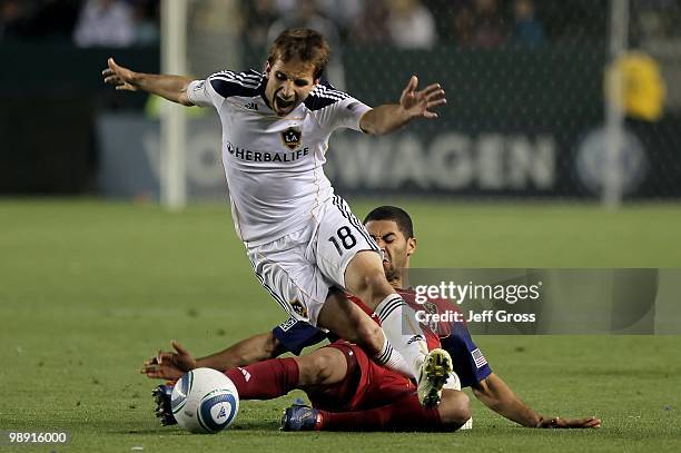 Mike Magee of the Los Angeles Galaxy is tackled by Alvaro Saborio of Real Salt Lake in the second half at the Home Depot Center on April 17, 2010 in...