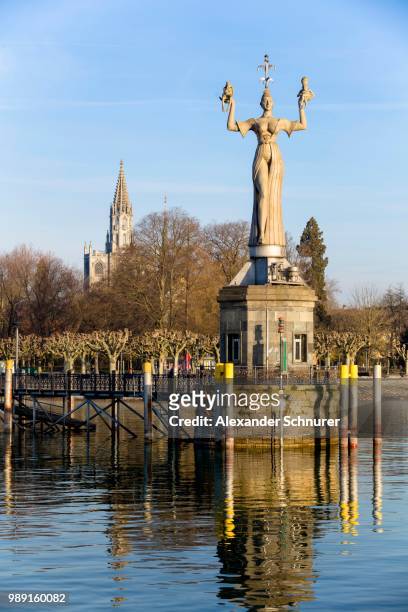 statue of imperia at the harbour of konstanz with konstanz cathedral behind, historic centre, konstanz, baden-wuerttemberg, germany - the minster building photos et images de collection