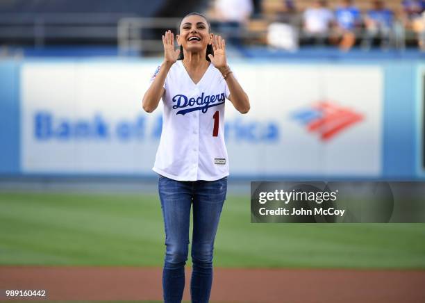 Actress Mila Kunis after throwing out the first pitch in Los Angeles Dodgers against Colorado Rockies at Dodger Stadium on June 29, 2018 in Los...