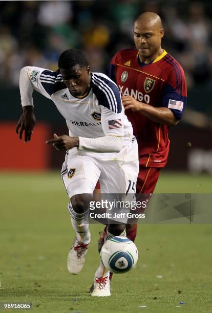 Edson Buddle of the Los Angeles Galaxy is pursued by Robbie Russell of Real Salt Lake for the ball at the Home Depot Center on April 17, 2010 in...