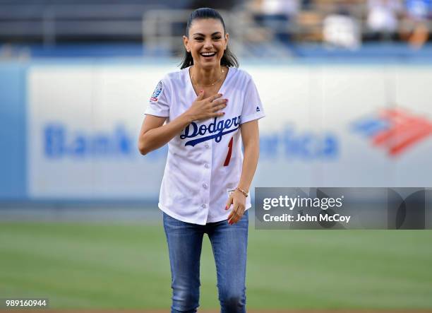 Actress Mila Kunis seen throwing out the first pitch in Los Angeles Dodgers against Colorado Rockies at Dodger Stadium on June 29, 2018 in Los...