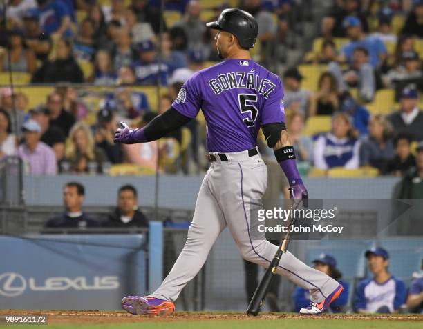 Carlos Gonzalez of the Colorado Rockies breaks his bat on a pitch from the Yimi Garcia of the Los Angeles Dodgers in the ninth inning at Dodger...