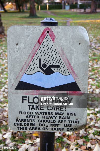 floodway warning sign near a storm water drainage ditch - hazardous area sign stock pictures, royalty-free photos & images