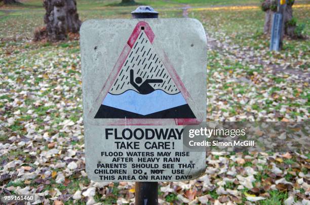 floodway warning sign near a storm water drainage ditch - severe weather alert stock pictures, royalty-free photos & images