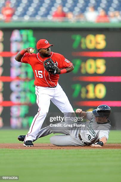 Cristian Guzman of the Washington Nationals forces out Chris Coghlan of the Florida Marlins to start a double play at Nationals Park on May 7, 2010...