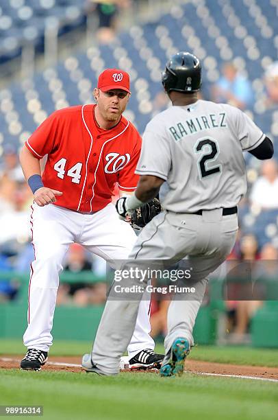 Hanley Ramirez of the Florida Marlins is tagged out at first base by Adam Dunn of the Washington Nationals at Nationals Park on May 7, 2010 in...