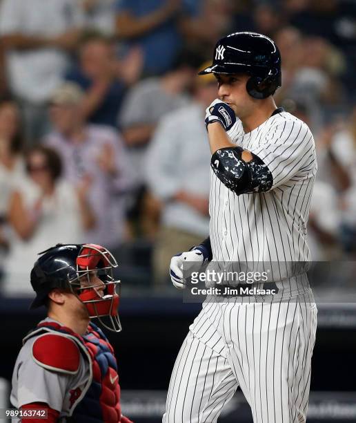 Kyle Higashioka of the New York Yankees reacts at home plate after his fourth inning home run as Christian Vazquez of the Boston Red Sox looks on at...
