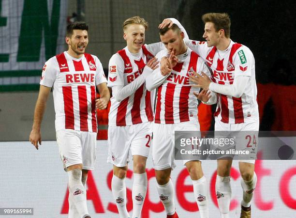 Cologne's goal scorer of the 1-0, Christian Clemens , celebrates with his team mates Milos Jojicc , Tim Handwerker and Lukas Kluenter during the...