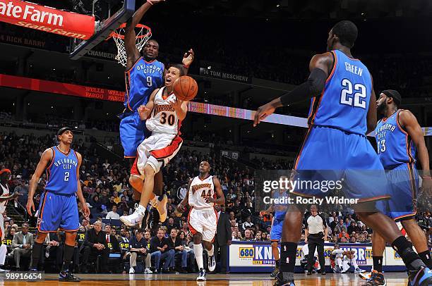 Stephen Curry of the Golden State Warriors loses the ball as he goes up for a shot against Serge Ibaka of the Oklahoma City Thunder during the game...