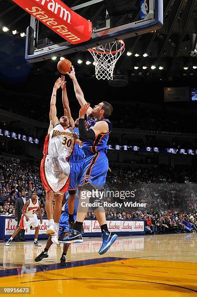 Stephen Curry of the Golden State Warriors shoots a layup against Nick Collison of the Oklahoma City Thunder during the game at Oracle Arena on April...