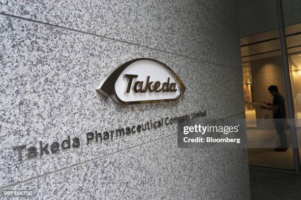 The Takeda Pharmaceutical Co. Logo is displayed at the company's global headquarters in Tokyo, Japan, on Monday, June 11, 2018. Melding futuristic...