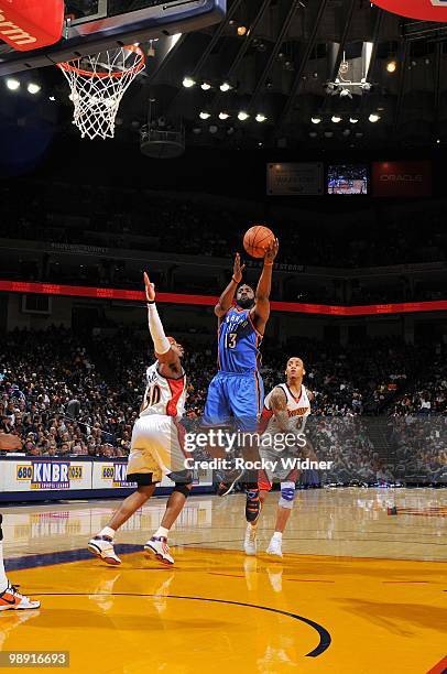 James Harden of the Oklahoma City Thunder shoots a layup against Corey Maggette and Monta Ellis of the Golden State Warriors during the game at...