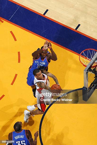 Monta Ellis of the Golden State Warriors shoots a layup against Serge Ibaka of the Oklahoma City Thunder during the game at Oracle Arena on April 11,...