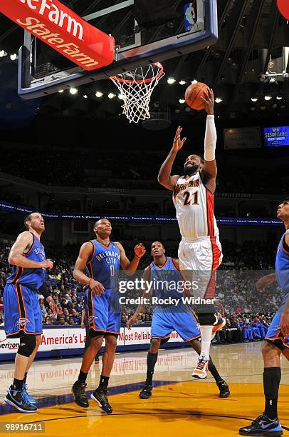 Ronny Turiaf of the Golden State Warriors shoots a layup against Nick Collison, Russell Westbrook and Kevin Durant of the Oklahoma City Thunder...