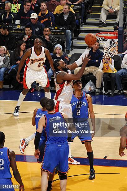 Ronny Turiaf of the Golden State Warriors shoots a layup against Russell Westbrook, Thabo Sefolosha and Nick Collison of the Oklahoma City Thunder...