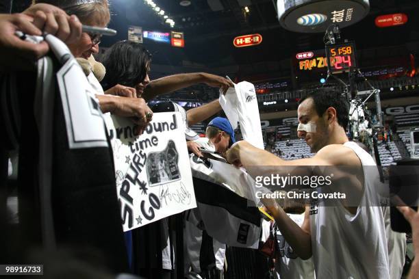 Manu Ginobili of the San Antonio Spurs signs autographs before playing the Phoenix Suns in Game Three of the Western Conference Semifinals during the...