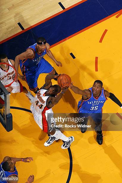 Anthony Tolliver of the Golden State Warriors rebounds against Kevin Durant of the Oklahoma City Thunder during the game at Oracle Arena on April 11,...