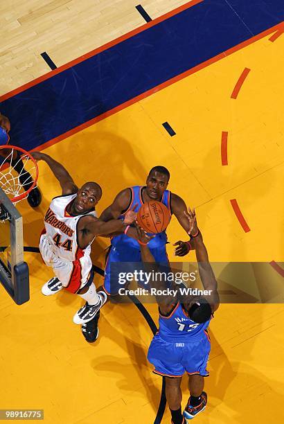 Anthony Tolliver of the Golden State Warriors rebounds against James Harden and Serge Ibaka of the Oklahoma City Thunder during the game at Oracle...