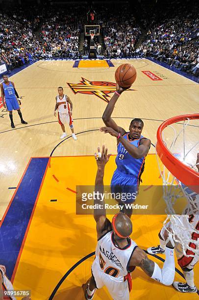 Serge Ibaka of the Oklahoma City Thunder goes up for a shot against Corey Maggette and Anthony Tolliver of the Golden State Warriors during the game...