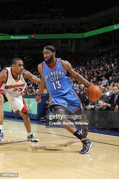 James Harden of the Oklahoma City Thunder drives to the basket against Reggie Williams of the Golden State Warriors during the game at Oracle Arena...