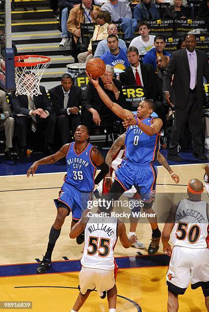 Russell Westbrook of the Oklahoma City Thunder shoots a layup against Reggie Williams and Corey Maggette of the Golden State Warriors during the game...