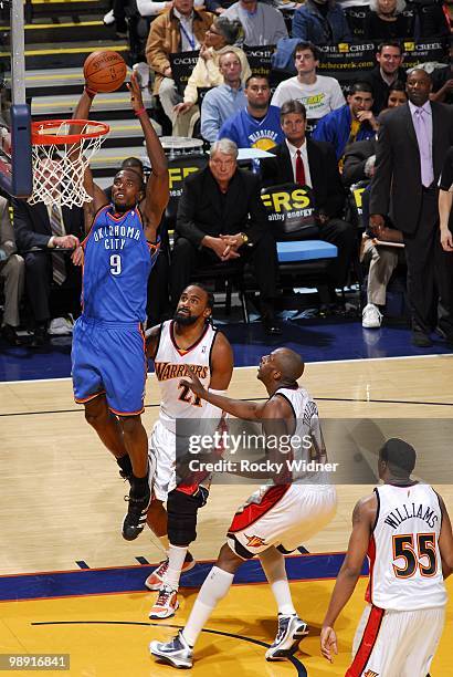 Serge Ibaka of the Oklahoma City Thunder goes up for a shot against Ronny Turiaf and Anthony Tolliver of the Golden State Warriors during the game at...