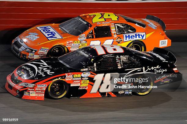 Kyle Busch, driver of the Z-Line Designs / Racing for Kids Toyota, races against Eric McClure, driver of the Hefty Odor Block Ford, during the NASCAR...