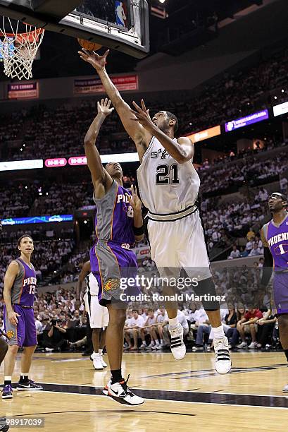 Forward Tim Duncan of the San Antonio Spurs takes a shot against Channing Frye of the Phoenix Suns in Game Three of the Western Conference Semifinals...