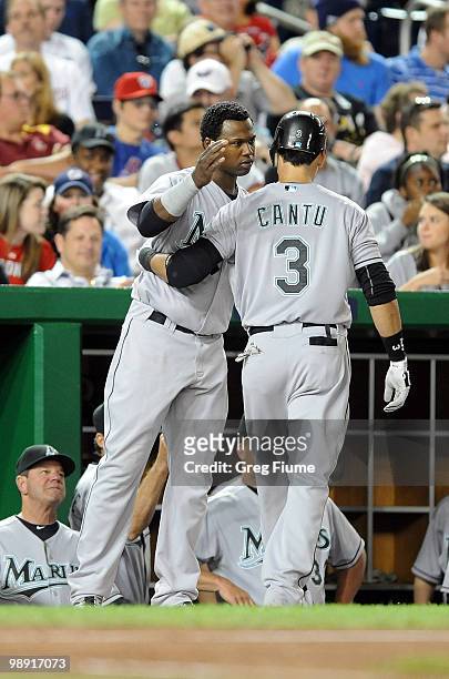 Jorge Cantu of the Florida Marlins is congratulated by Hanley Ramirez after hitting a home run in the seventh inning against the Washington Nationals...