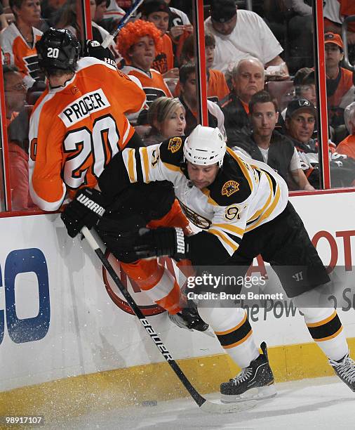 Marc Savard of the Boston Bruins hits Chris Pronger of the Philadelphia Flyers in Game Four of the Eastern Conference Semifinals during the 2010 NHL...