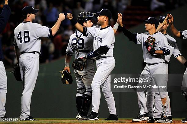 Boone Logan, Francisco Cervelli, Derek Jeter, and Ramiro Pena of the New York Yankees high five following their win over the Boston Red Sox May 7,...