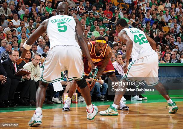 LeBron James of the Cleveland Cavaliers looks for a play against Tony Allen and Kevin Garnett of the Boston Celtics in Game Three of the Eastern...