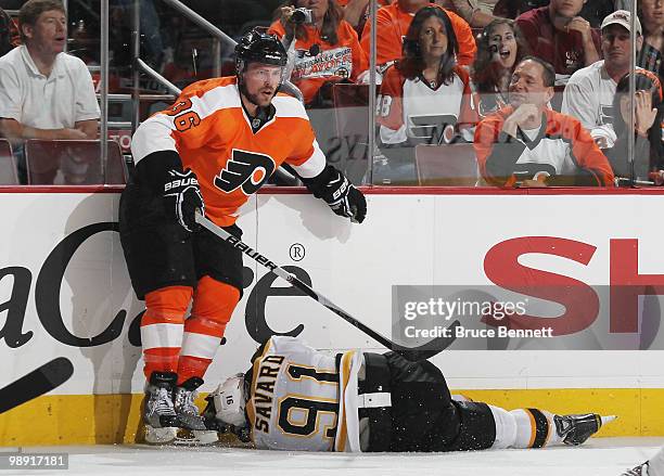 Marc Savard of the Boston Bruins is a victim of a boarding penalty by Darroll Powe of the Philadelphia Flyers in Game Four of the Eastern Conference...