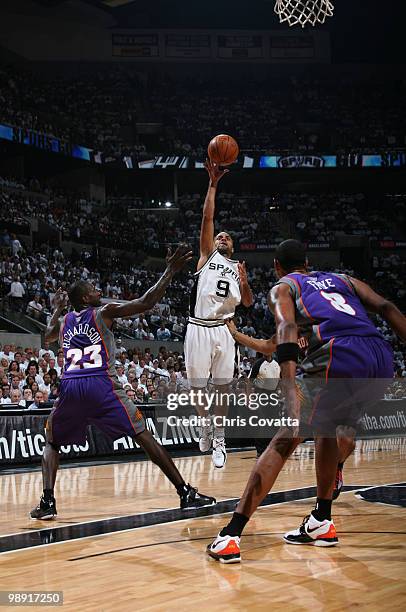 Tony Parker of the San Antonio Spurs shoots over Jason Richardson and Channing Frye of the Phoenix Suns in Game Three of the Western Conference...