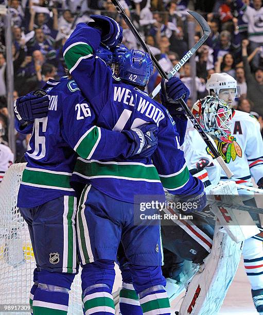 Kyle Wellwood of the Vancouver Canucks celebrates with teammate Mikael Samuelsson after scoring against goalie Antti Niemi of the Chicago Blackhawks...