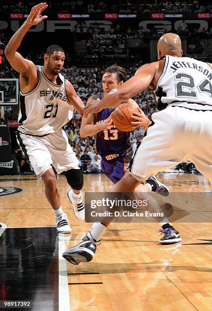 Steve Nash of the Phoenix Suns drives against Tim Duncan and Richard Jefferson of the San Antonio Spurs in Game Three of the Western Conference...