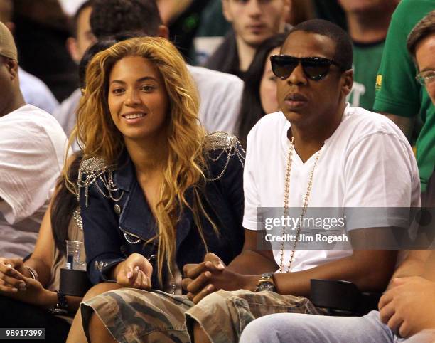 Singers Beyonce and Jay-Z sit courtside during a game between the Cleveland Cavaliers and the Boston Celtics during Game Three of the Eastern...