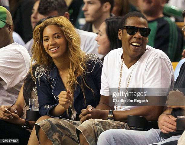 Singers Beyonce and Jay-Z sit courtside during a game between the Cleveland Cavaliers and the Boston Celtics during Game Three of the Eastern...