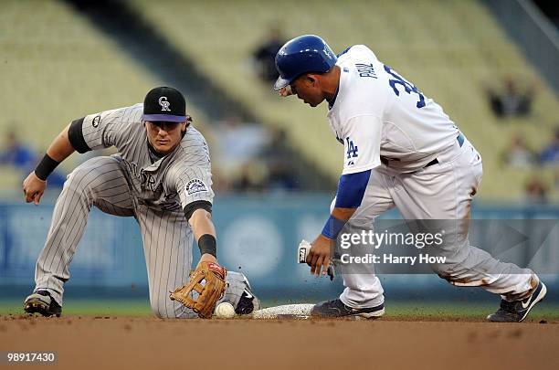 Xavier Paul of the Los Angeles Dodgers steals second base in front of Troy Tulowitzki of the Colorado Rockies during the first inning at Dodger...
