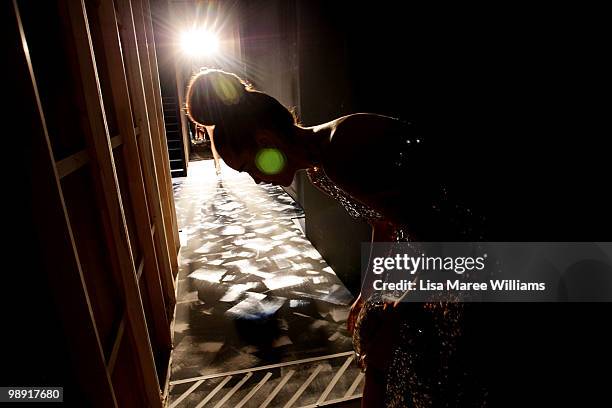 Model takes off her shoes side of stage after walking the runway during Rachel Gilbert's show at Rosemount Australian Fashion Week Spring/Summer...