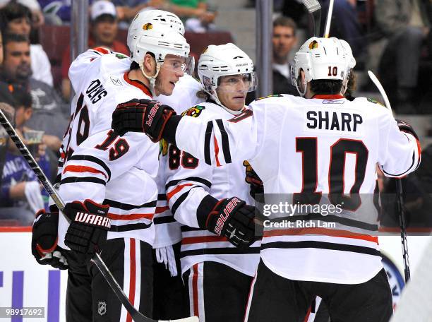 Jonathan Toews celebrates with Patrick Kane and Patrick Sharp of the Chicago Blackhawks after scoring against the Vancouver Canucks during the second...